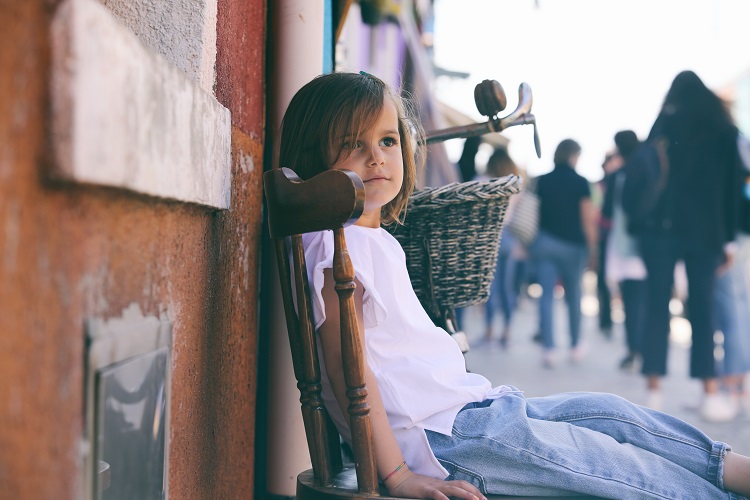 A little girl sitting on top of a chair.