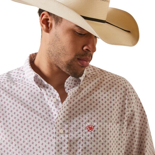 A man wearing a cowboy hat and a white shirt.