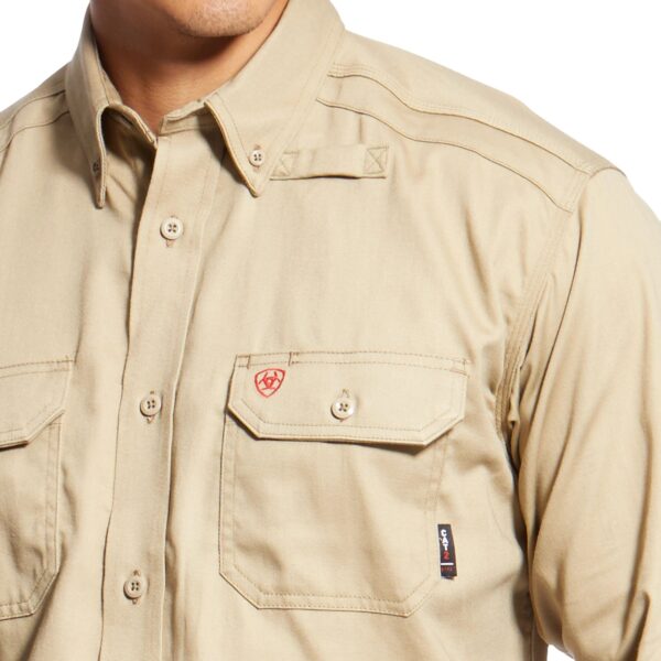 A man wearing a tan shirt with two pockets.