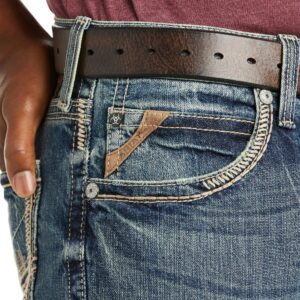 A close up of someone 's jeans with their belt around them.