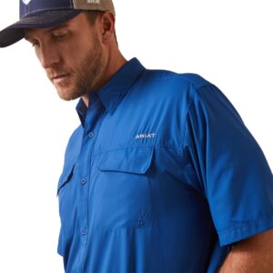 A man wearing a hat and blue shirt.