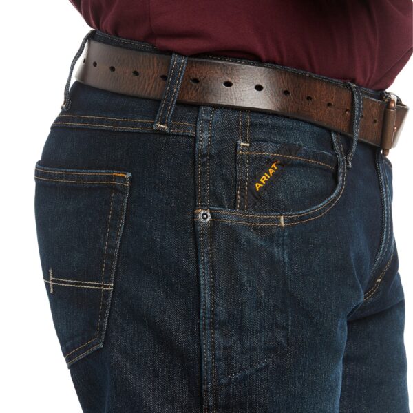 A close up of the waist and belt on a man 's jeans.