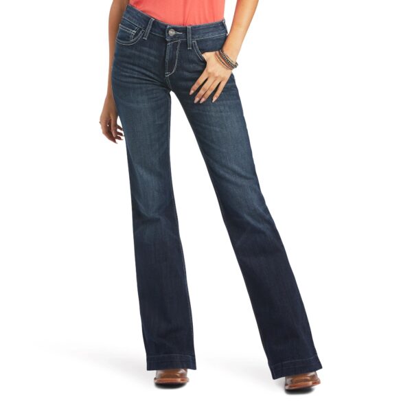 A woman wearing jeans and heels is standing.