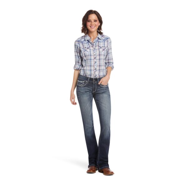 A woman wearing jeans and a plaid shirt.