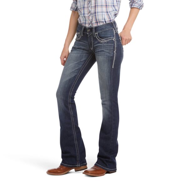 A woman wearing jeans and brown shoes.