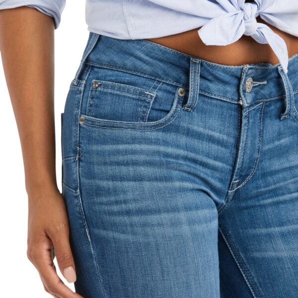 A close up of the waist and hips of someone wearing jeans.