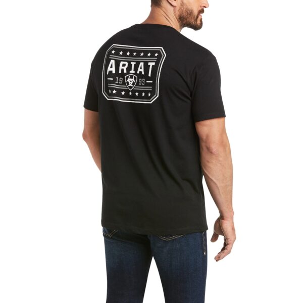 A man wearing a black t-shirt with the word ariat on it.