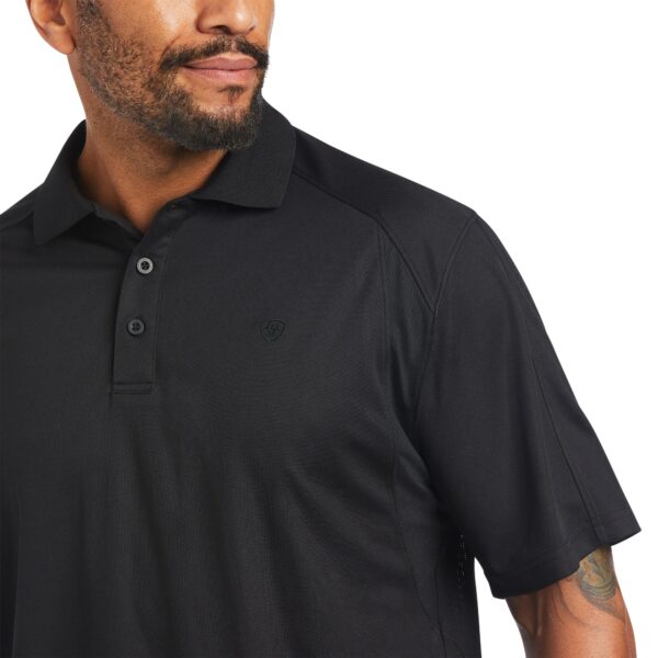 A man wearing black polo shirt with pocket.