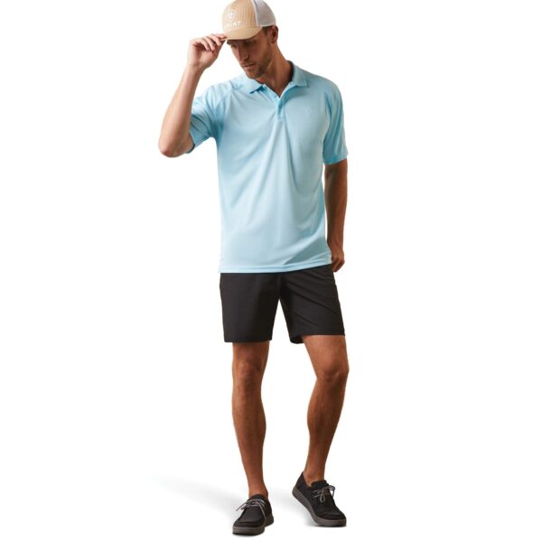 A man in blue shirt and black shorts