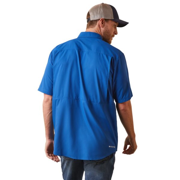 A man wearing a blue shirt and hat.