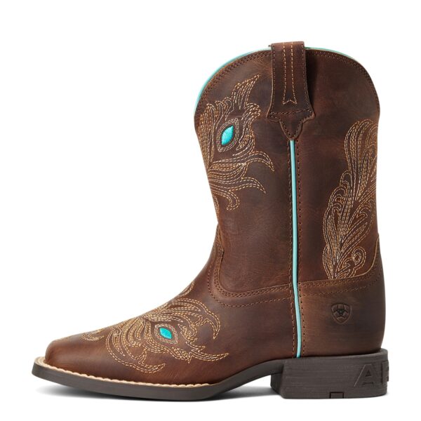 A brown cowboy boot with turquoise accents on top of it.