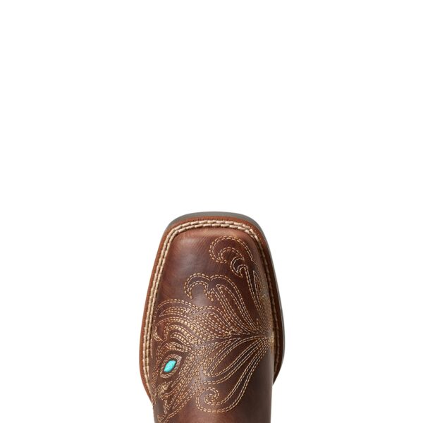 A brown cowboy boot with turquoise accents on top of it.