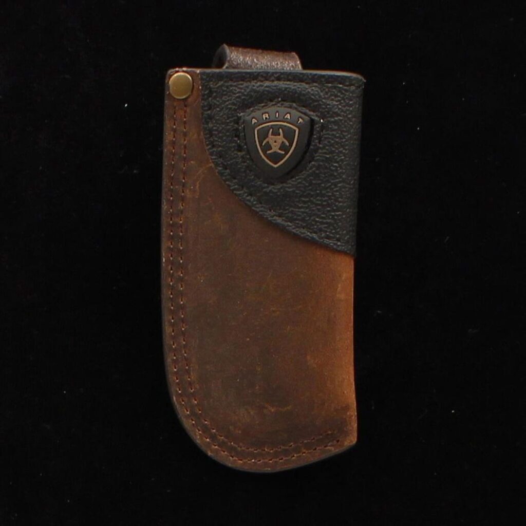 A brown and black leather case with a metal clip.