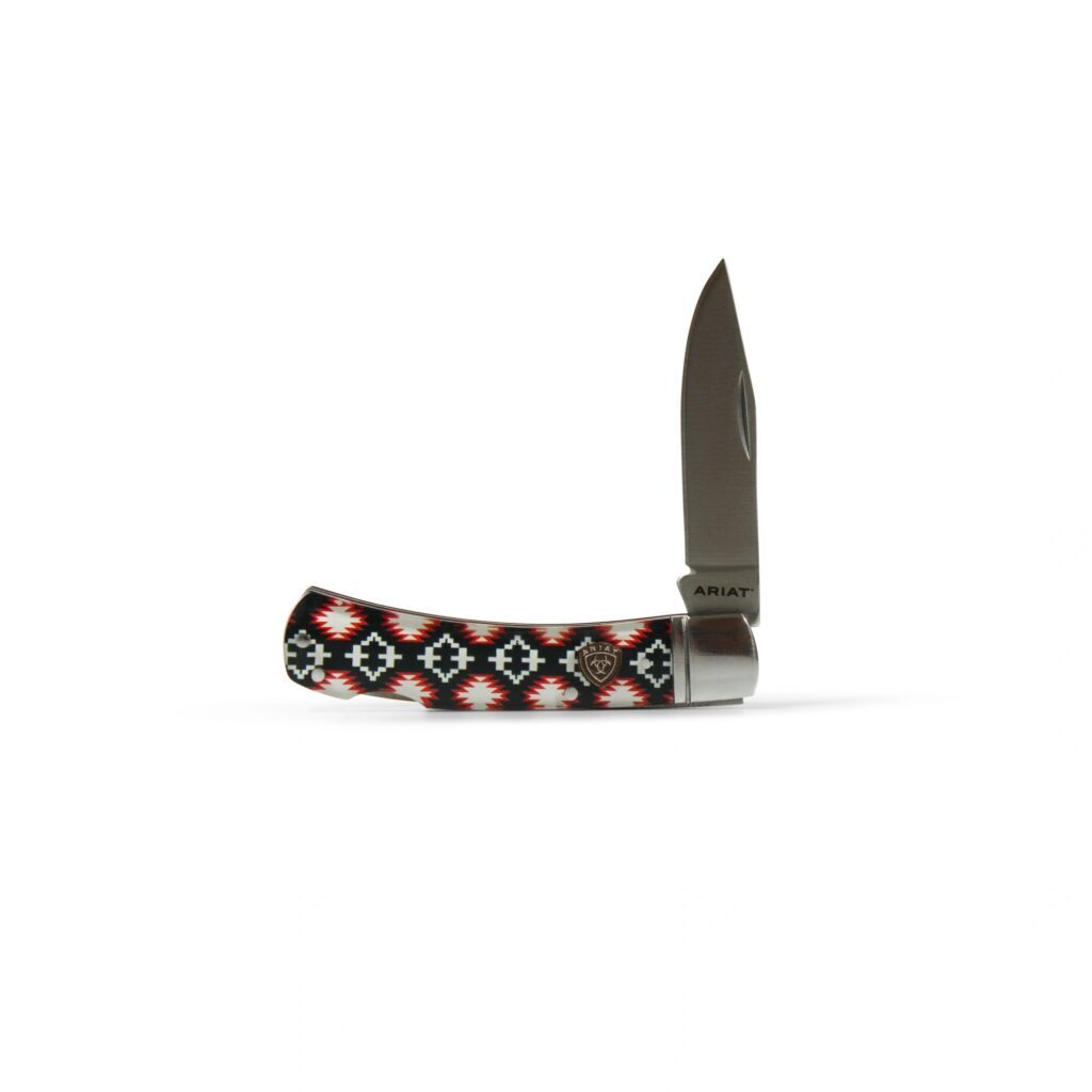 A knife with a patterned handle on top of it.