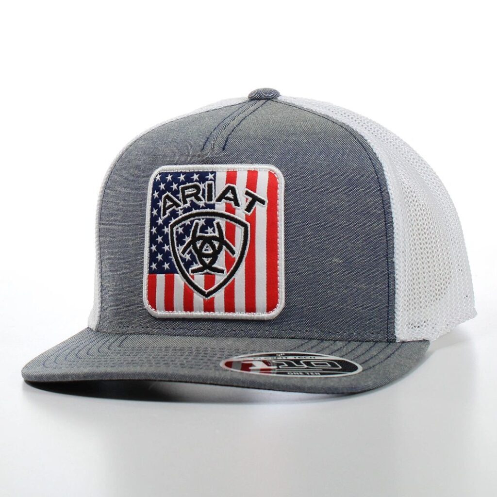 A gray and white hat with an american flag patch.