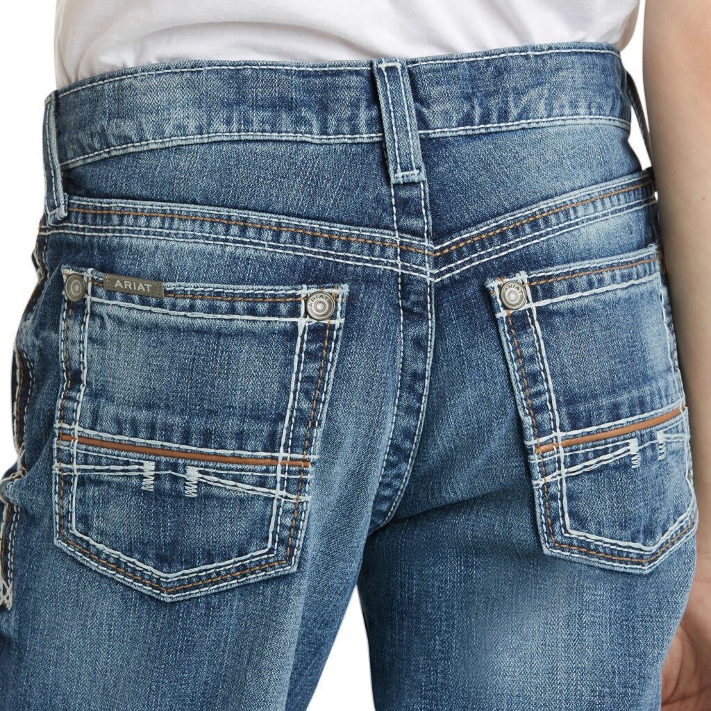 A person wearing jeans with their back to the camera.