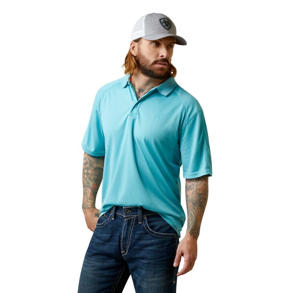 A man with beard and cap wearing blue shirt.