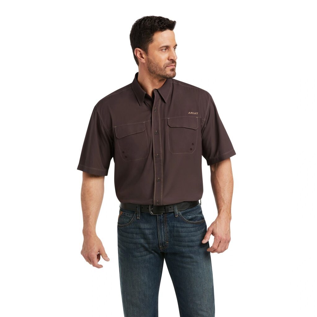 A man wearing jeans and brown shirt.