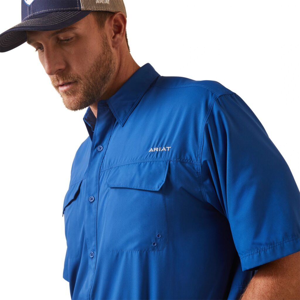 A man wearing a hat and blue shirt.