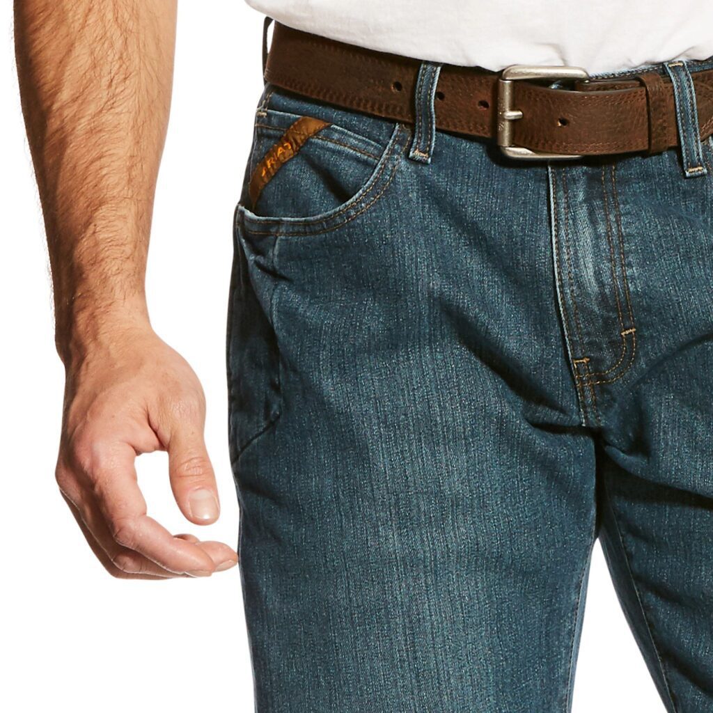 A man wearing jeans and a brown belt.